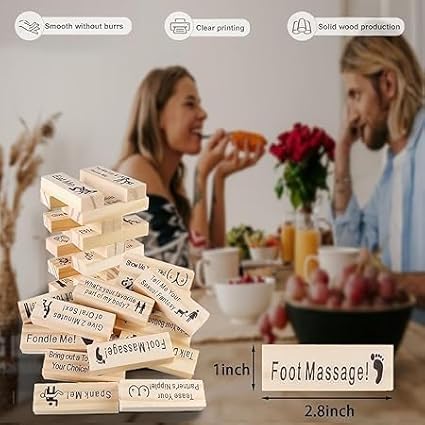 Wooden block tower game with text labels on a table, people in the background