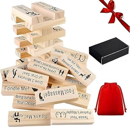 Wooden sex-themed joke blocks with a black box and red drawstring bag on a white background