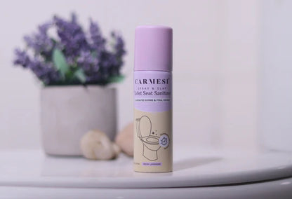 Carmes toilet seat sanitizer on a bathroom counter with lavender flowers in the background